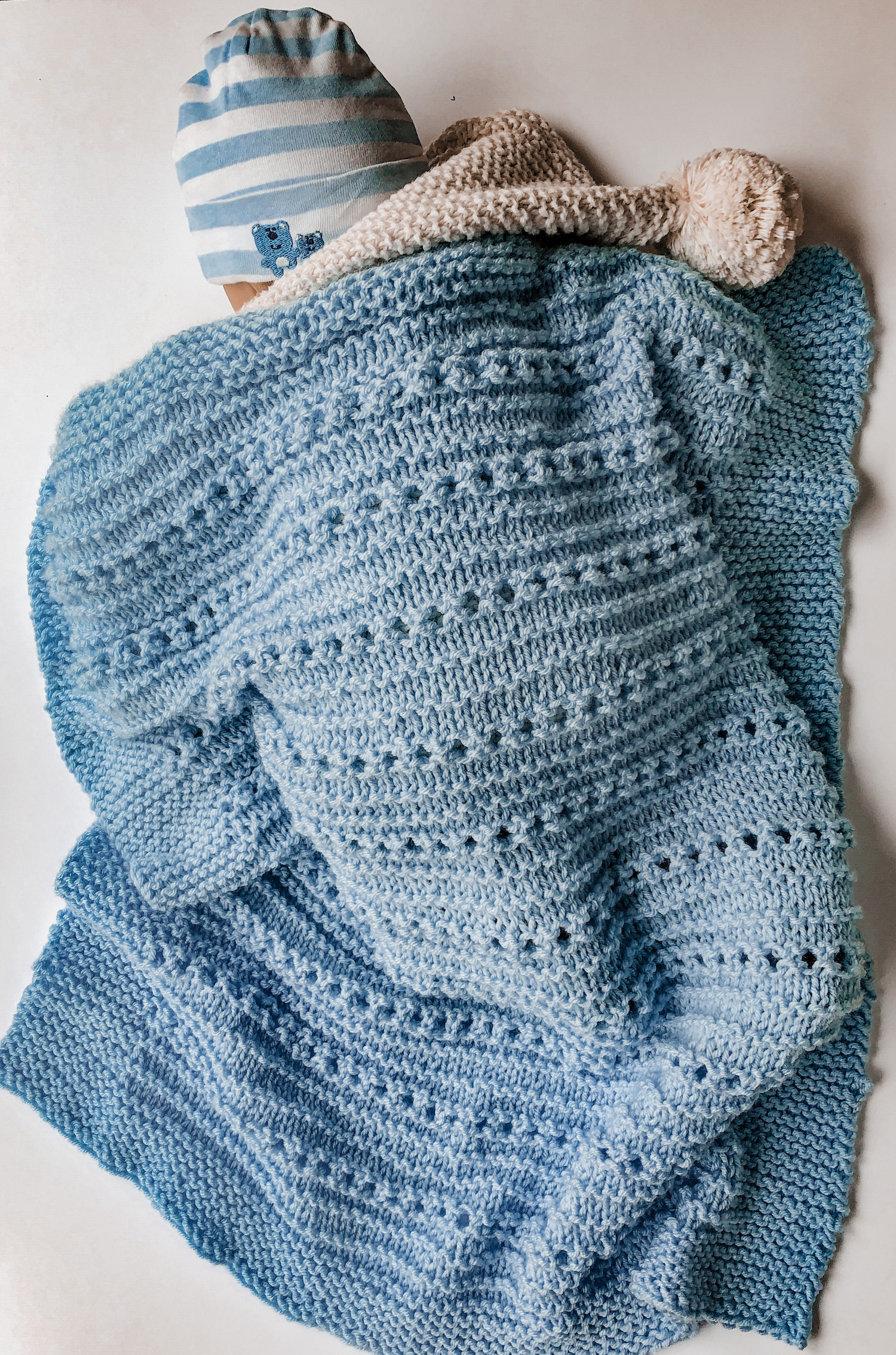 baby sleeping with cuddly blue knit baby blanket