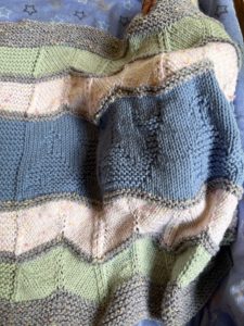 handknit blanket on sleeping baby