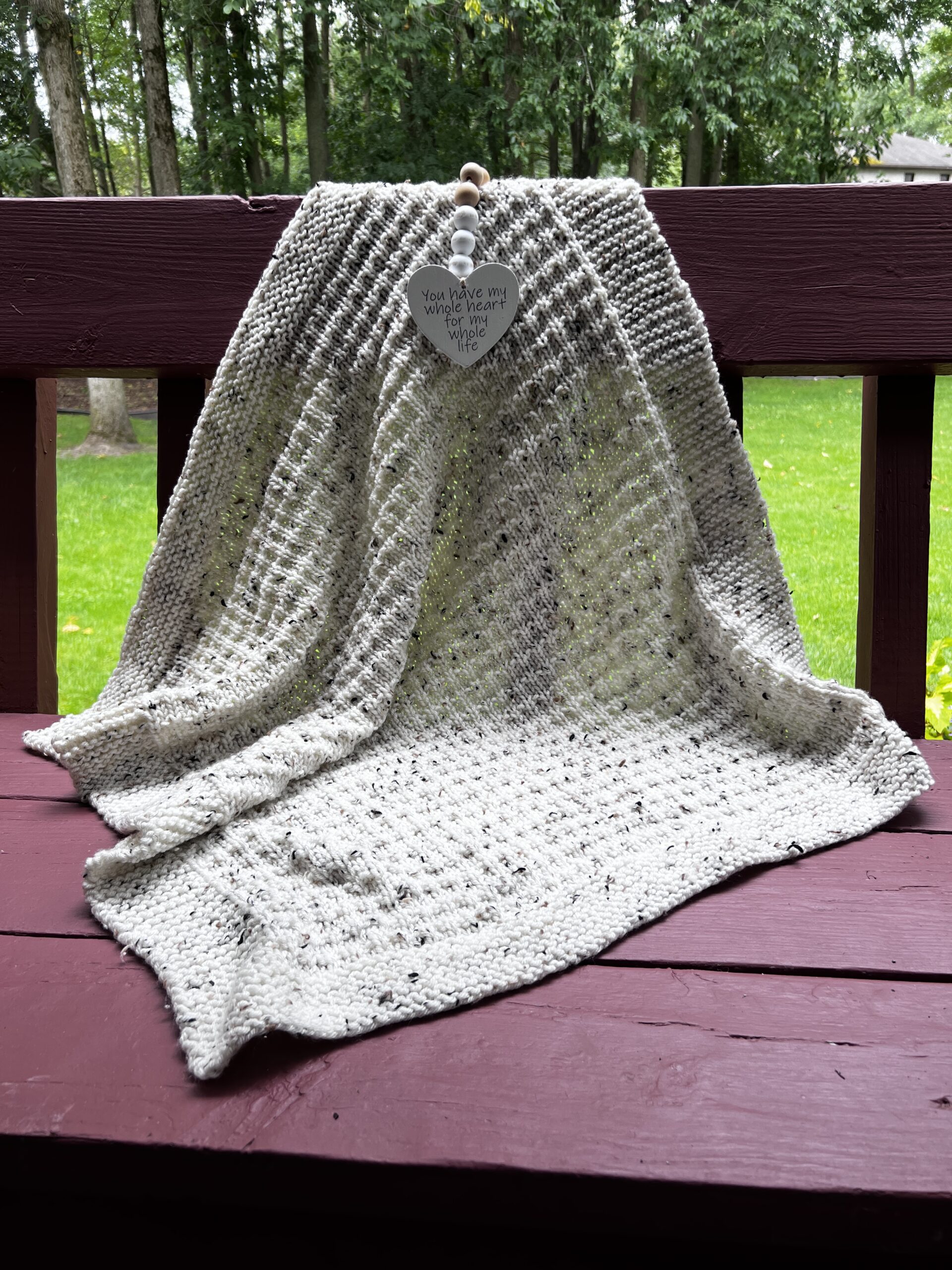 tweed ivory blanket on redwood bench