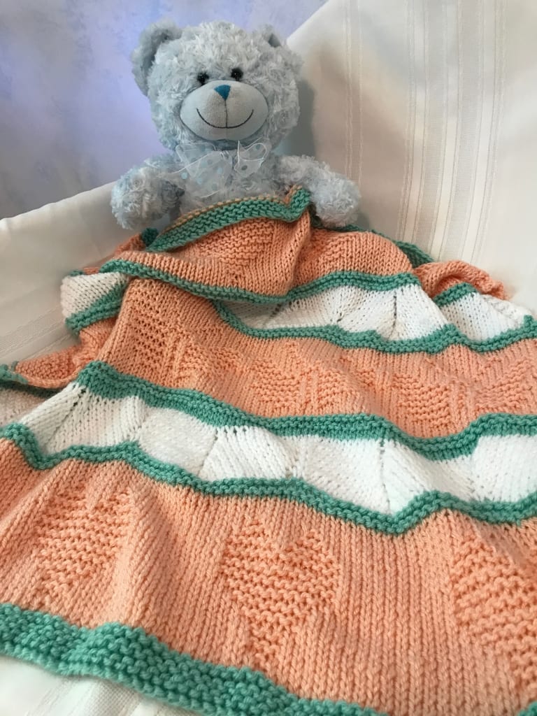 teddy bear and peach blanket