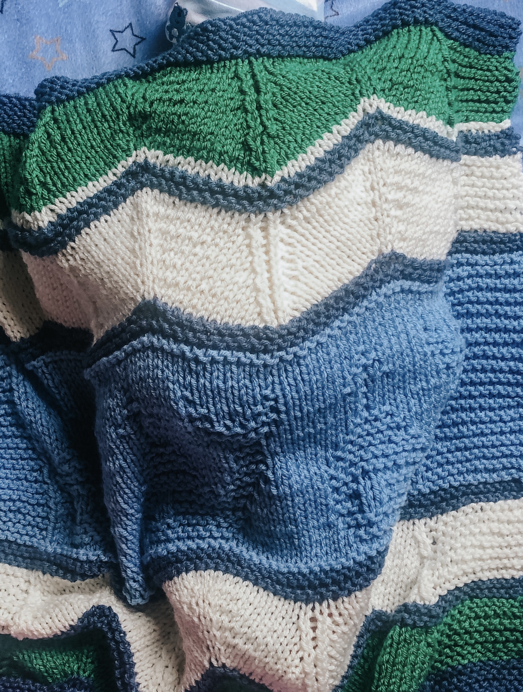 green white and blue handknit baby blanket