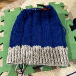handknit blue hat with gray brim