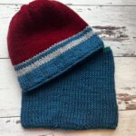 red, blue and gray striped hat with matching blue neckwarmer
