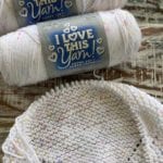 2 skeins of yarn and beginning knit blanket