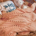 textured baby blanket with doll and baby