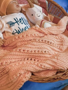 textured baby blanket with doll and baby