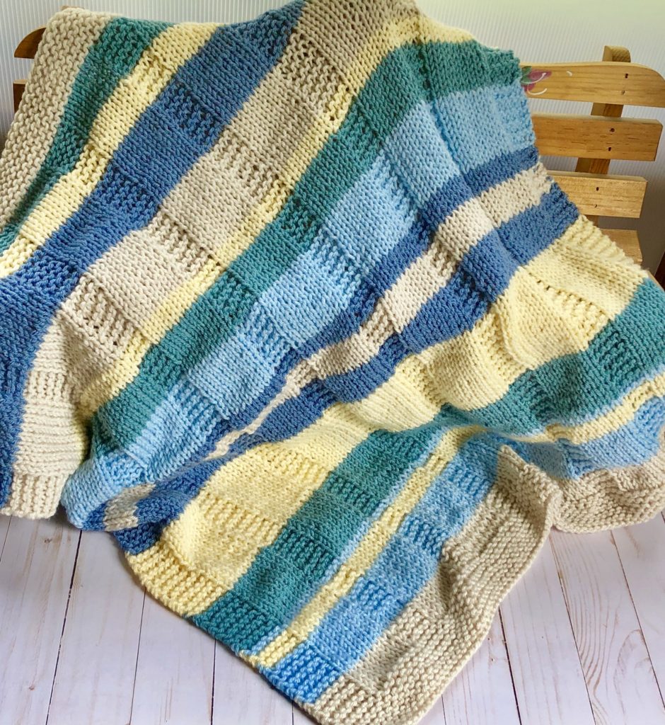 plaid like knit blanket on bench