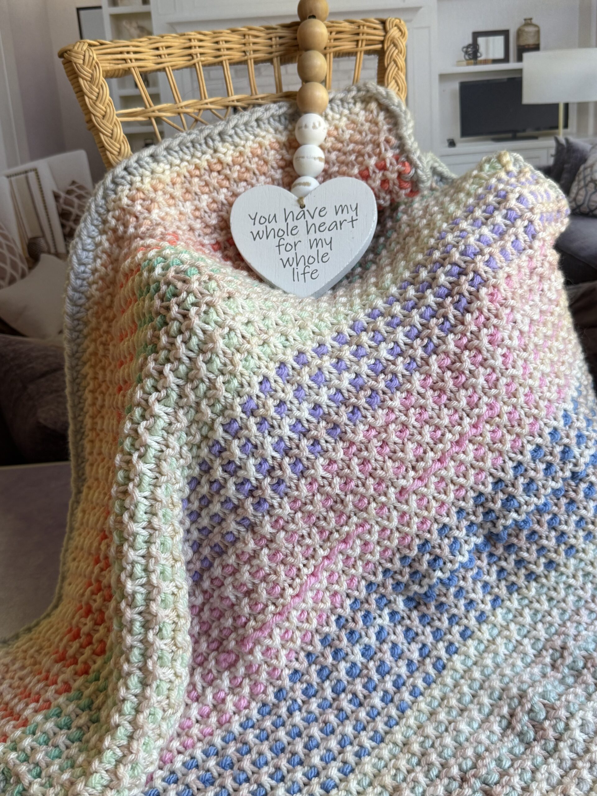 textured baby blanket draped on chair