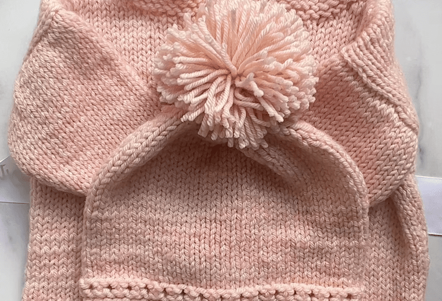 pink sweater and matching pompom hat
