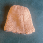 the lining of a hat in peach