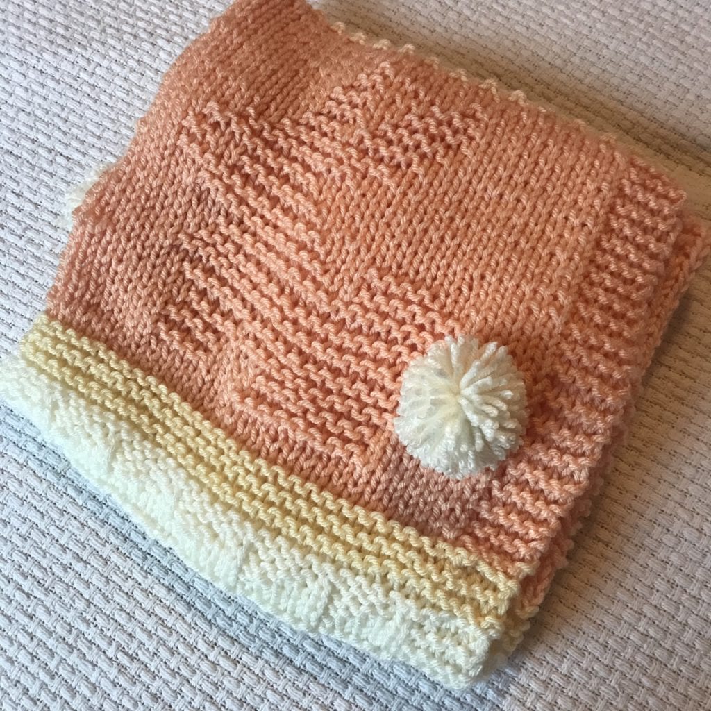 folded peach blanket with bunny