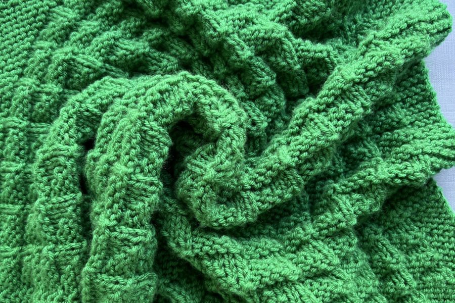 green textured baby blanket