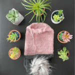 pink scarf, pompom and succulents