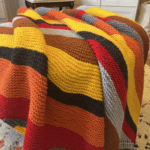 striped knit blanket in fiery colors