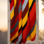 handknit striped blanket on ladder