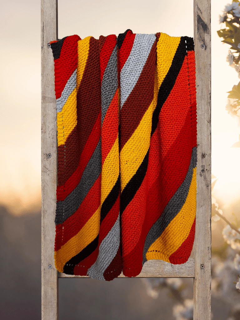 handknit striped blanket on ladder