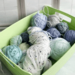 partial skeins of yarn in a green basket