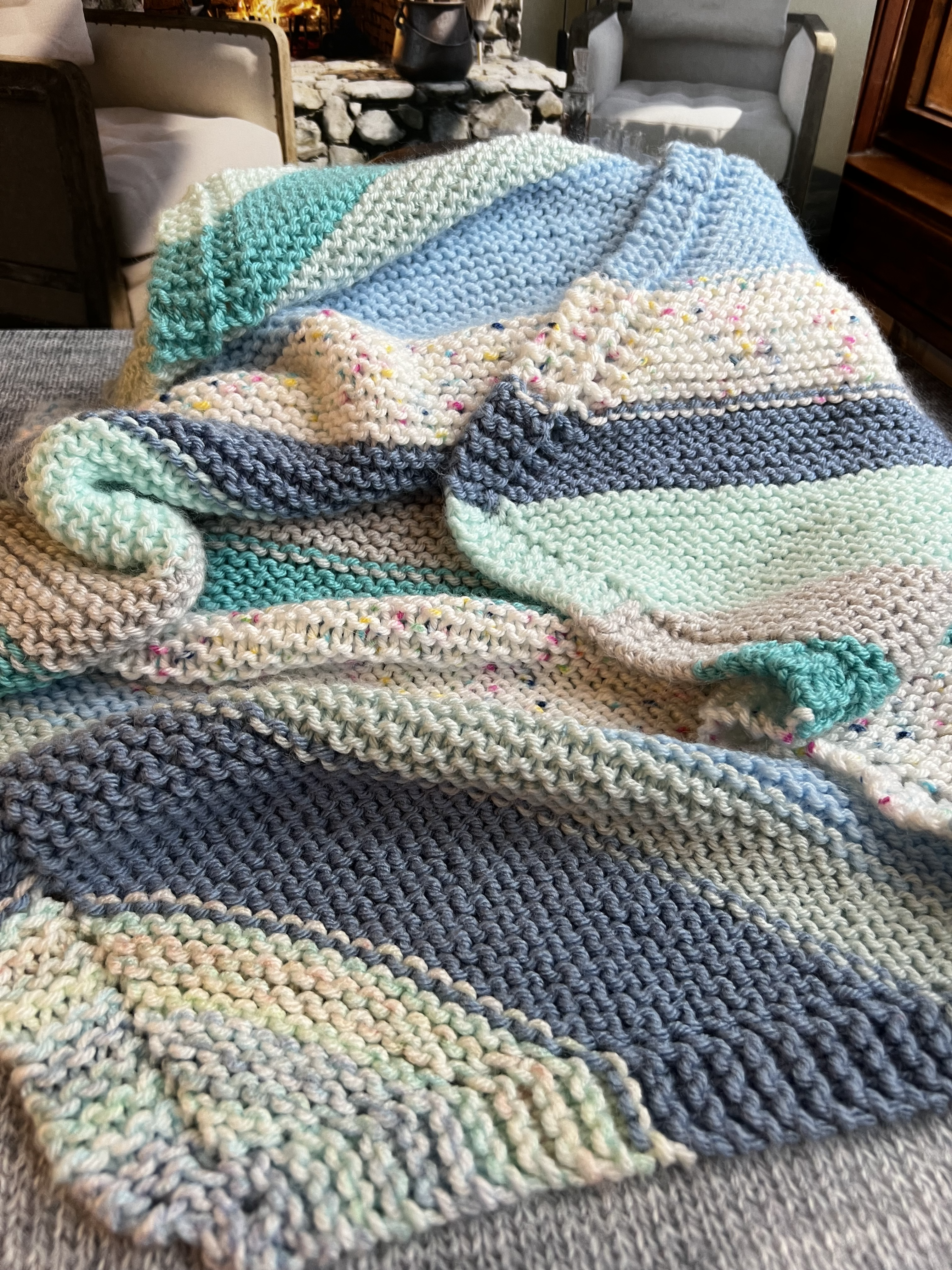 handknit baby blanket in blues and aquas