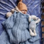 baby sleeping with lamb and baby blanket