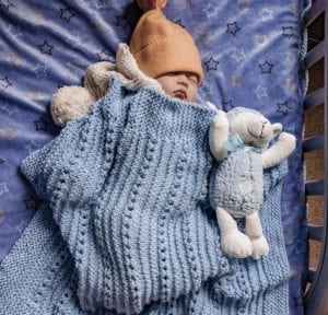 baby sleeping with lamb and baby blanket