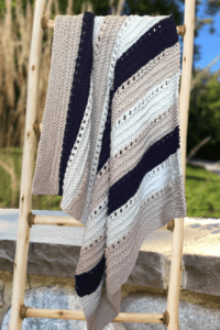 striped baby blanket on ladder