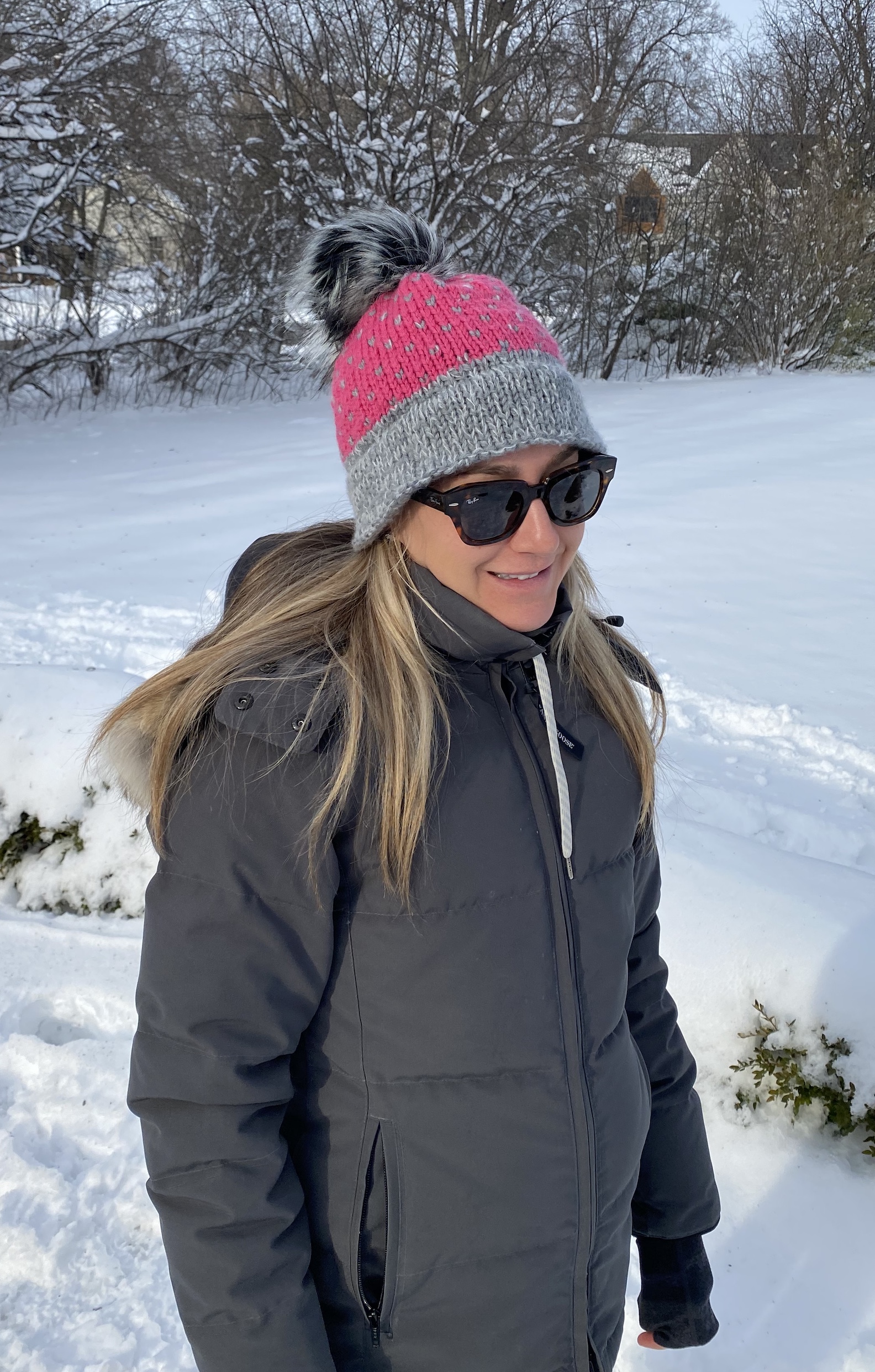 woman with pink and gray hat and pompom