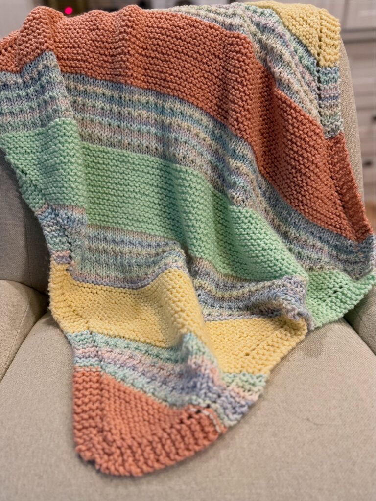 striped knit blanket draped on a chair