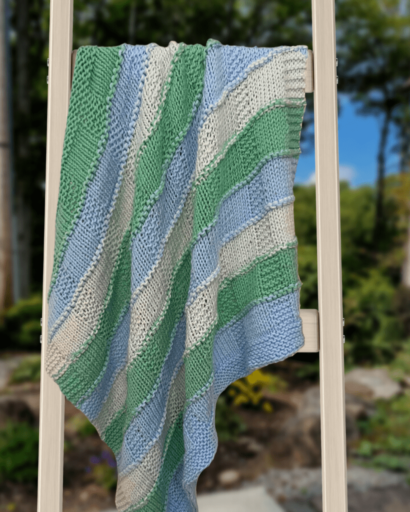 striped baby blanket on ladder