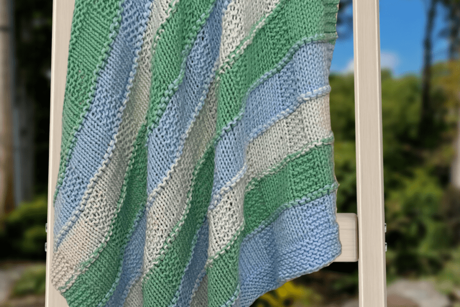 striped baby blanket on ladder