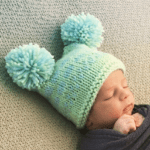 baby with knit pompom hat