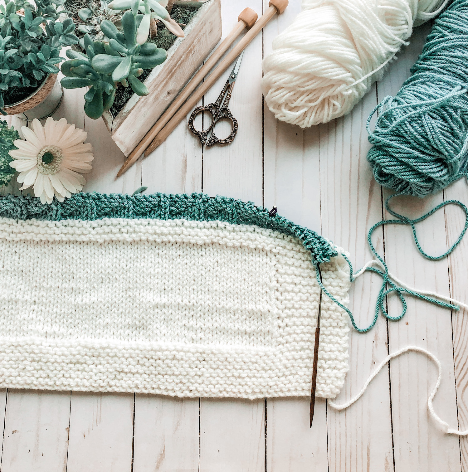 flatlay photo with cream and aqua yarn for baby blanket