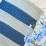 blue and white knit blanket with flowers