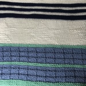 green, blue and white blanket with stars