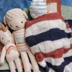 flag blanket with sleeping baby and dolls