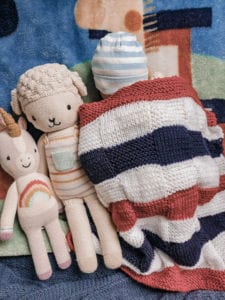 flag blanket with sleeping baby and dolls