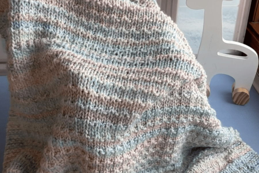 handknit blanket draped across chair