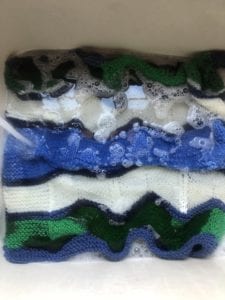 knit blanket in sudsy water