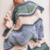 baby sleeping with knit blanket